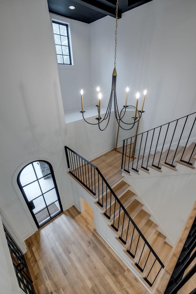 1050 Garton Rd, Burns, TN 37029 - stairs featuring wood finished floors, a chandelier, and a high ceiling