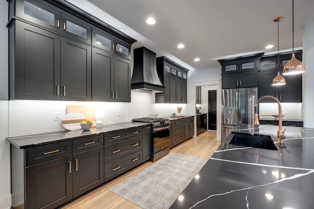 1050 Garton Rd, Burns, TN 37029 - kitchen featuring black gas stove, custom range hood, light wood finished floors, decorative backsplash, and recessed lighting