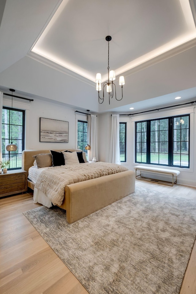 1050 Garton Rd, Burns, TN 37029 - bedroom with a raised ceiling, light wood-style flooring, and a chandelier