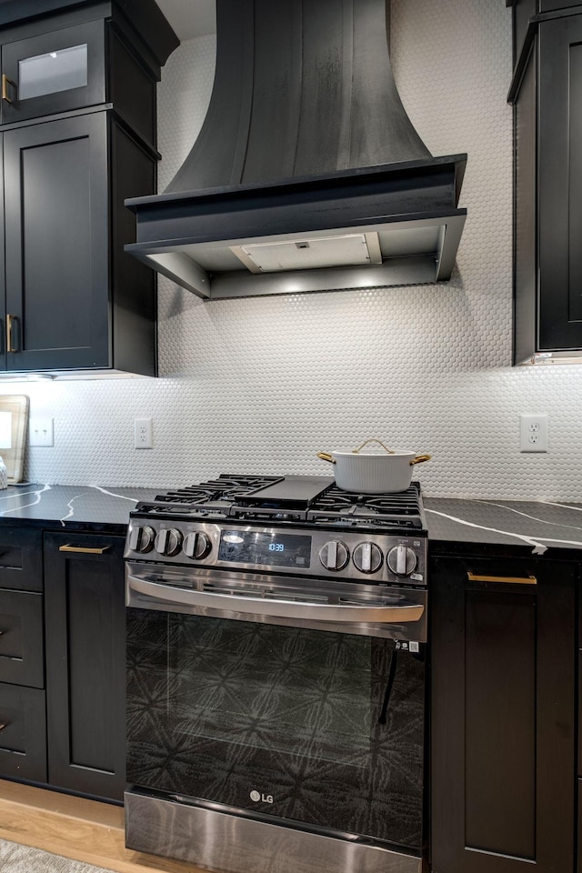 1050 Garton Rd, Burns, TN 37029 - kitchen featuring stainless steel gas stove, custom exhaust hood, decorative backsplash, and light wood finished floors