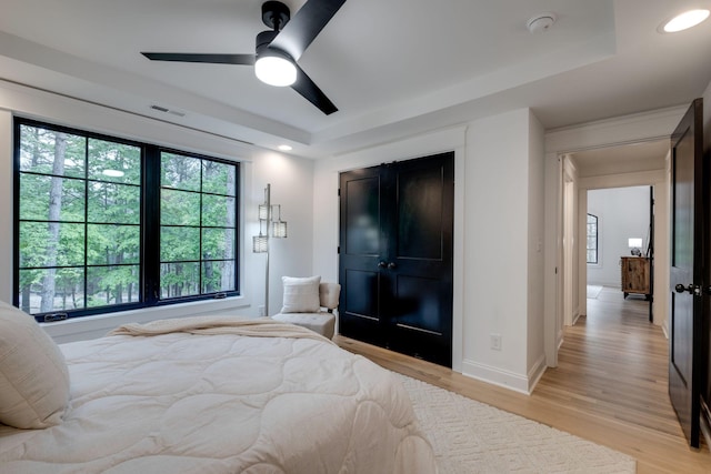 1050 Garton Rd, Burns, TN 37029 - bedroom featuring light wood-type flooring, a raised ceiling, baseboards, ceiling fan, and recessed lighting
