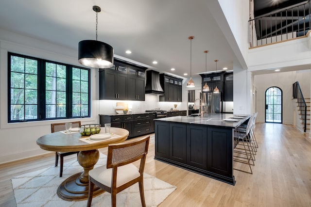 1050 Garton Rd, Burns, TN 37029 - kitchen featuring custom range hood, dark cabinets, stainless steel appliances, light wood-type flooring, and recessed lighting