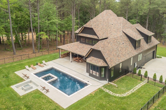 1050 Garton Rd, Burns, TN 37029 - view of swimming pool featuring a patio, a forest view, and a pool with connected hot tub