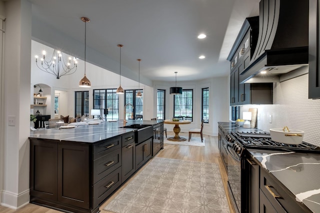 1050 Garton Rd, Burns, TN 37029 - kitchen with a sink, stainless steel gas stove, light wood-style flooring, tasteful backsplash, and recessed lighting