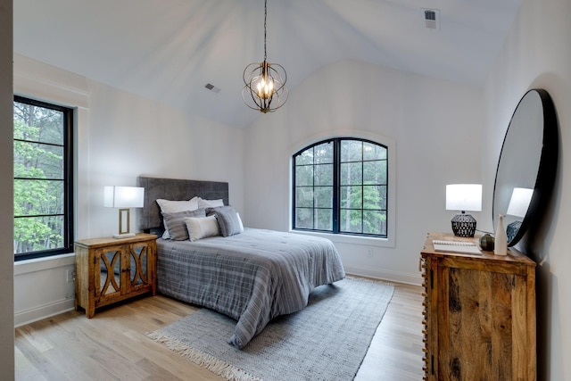 1050 Garton Rd, Burns, TN 37029 - bedroom with multiple windows, a chandelier, light wood finished floors, and lofted ceiling