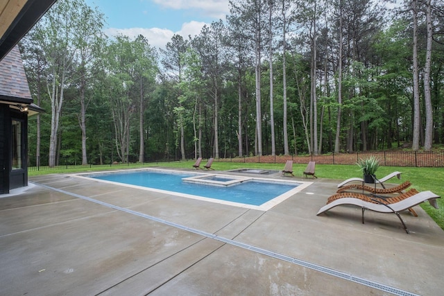 1050 Garton Rd, Burns, TN 37029 - view of swimming pool featuring a patio area, a pool with connected hot tub, and a view of trees
