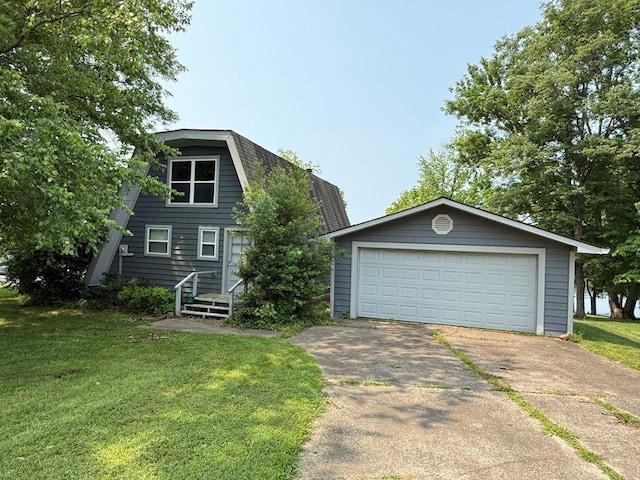 517 Bay Ln, Cadiz, KY 42211 - a-frame style home with a detached garage, a front yard, and a gambrel roof