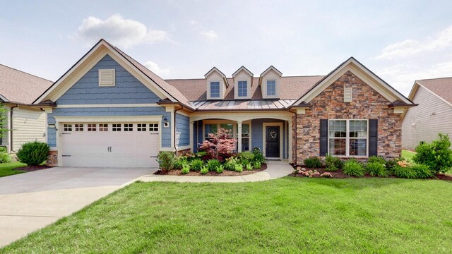 1106 Davidson Walk, Spring Hill, TN 37174 - view of front of house featuring stone siding, a front yard, an attached garage, driveway, and a standing seam roof