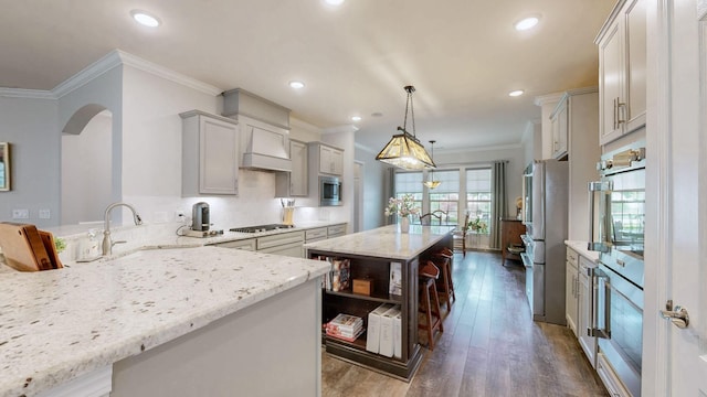 1106 Davidson Walk, Spring Hill, TN 37174 - kitchen featuring stainless steel appliances, light stone countertops, open shelves, a center island, and dark wood-style flooring