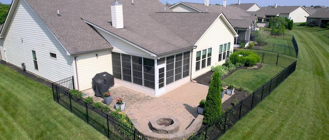 1106 Davidson Walk, Spring Hill, TN 37174 - back of property featuring a sunroom, roof with shingles, a patio, a fire pit, and a chimney