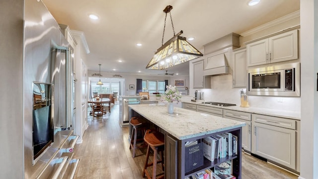 1106 Davidson Walk, Spring Hill, TN 37174 - kitchen featuring stainless steel appliances, a peninsula, open shelves, crown molding, and light stone countertops
