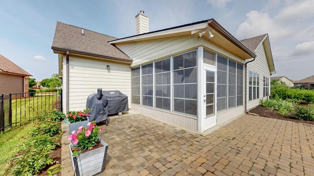 1106 Davidson Walk, Spring Hill, TN 37174 - back of property with a sunroom, a patio, a chimney, and roof with shingles