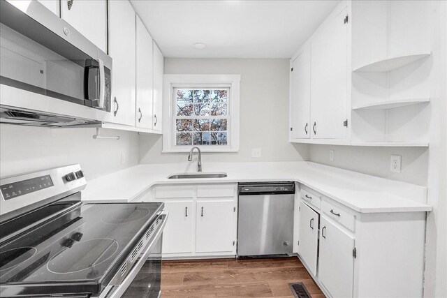 1115 Grantland Ave, Murfreesboro, TN 37129 - kitchen with appliances with stainless steel finishes, a sink, open shelves, white cabinets, and wood finished floors