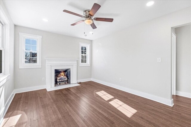 1115 Grantland Ave, Murfreesboro, TN 37129 - unfurnished living room featuring a fireplace with flush hearth, wood finished floors, baseboards, and recessed lighting