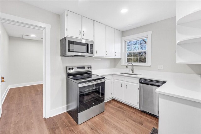 1115 Grantland Ave, Murfreesboro, TN 37129 - kitchen featuring stainless steel appliances, a sink, open shelves, light countertops, and white cabinets
