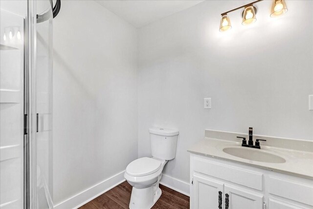 1115 Grantland Ave, Murfreesboro, TN 37129 - bathroom featuring vanity, wood finished floors, toilet, baseboards, and a shower