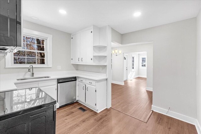 1115 Grantland Ave, Murfreesboro, TN 37129 - kitchen with stainless steel dishwasher, a sink, a chandelier, light countertops, and open shelves