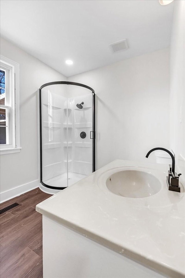 1115 Grantland Ave, Murfreesboro, TN 37129 - bathroom featuring a sink, a stall shower, wood finished floors, and baseboards