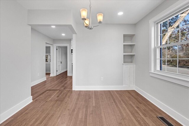 1115 Grantland Ave, Murfreesboro, TN 37129 - unfurnished dining area with wood finished floors, a chandelier, baseboards, and recessed lighting