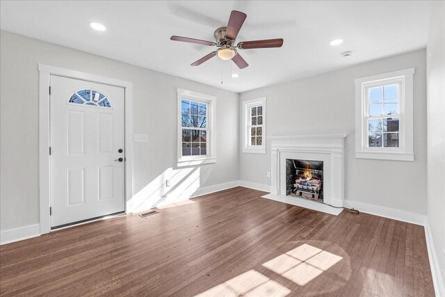 1115 Grantland Ave, Murfreesboro, TN 37129 - unfurnished living room with a fireplace with flush hearth, plenty of natural light, baseboards, wood finished floors, and recessed lighting