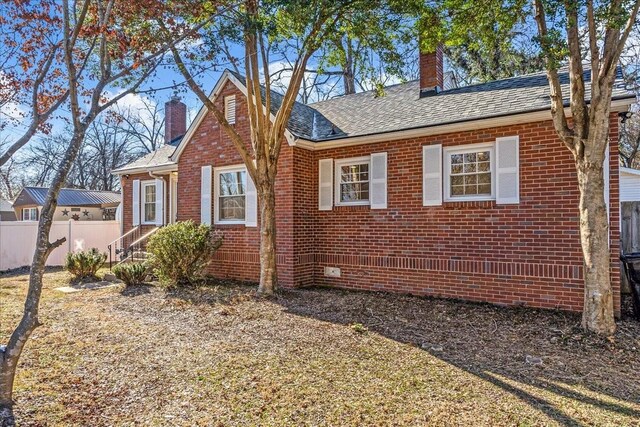 1115 Grantland Ave, Murfreesboro, TN 37129 - view of front of home with a chimney, brick siding, and a shingled roof