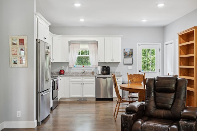 1505 Bakers Work Rd, Burns, TN 37029 - kitchen with appliances with stainless steel finishes, dark wood-style floors, white cabinetry, light stone counters, and recessed lighting
