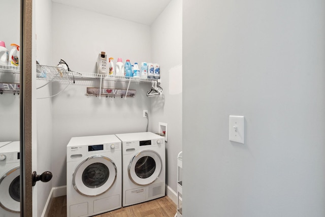 1505 Bakers Work Rd, Burns, TN 37029 - laundry area featuring washer and dryer, light wood-type flooring, and baseboards