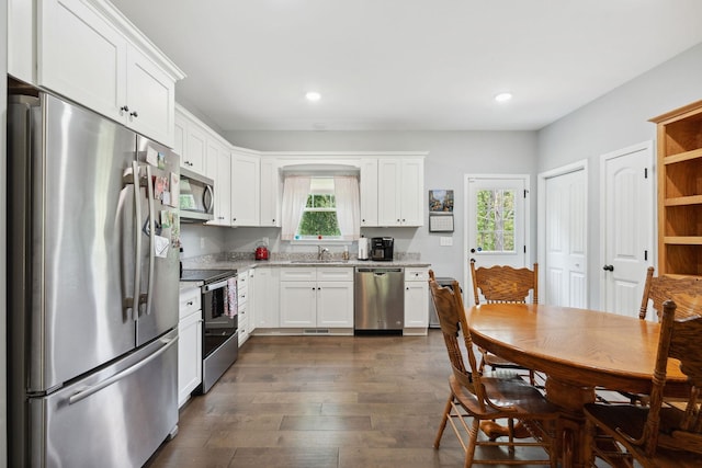 1505 Bakers Work Rd, Burns, TN 37029 - kitchen with stainless steel appliances, a sink, dark wood finished floors, white cabinets, and light stone counters