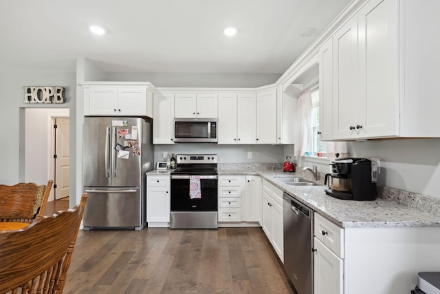 1505 Bakers Work Rd, Burns, TN 37029 - kitchen featuring appliances with stainless steel finishes, a sink, white cabinetry, and recessed lighting