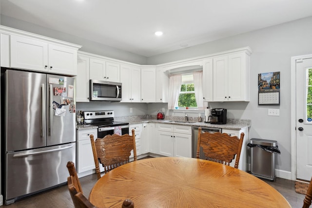 1505 Bakers Work Rd, Burns, TN 37029 - kitchen featuring appliances with stainless steel finishes, a sink, white cabinetry, dark wood-style flooring, and recessed lighting