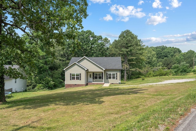 1505 Bakers Work Rd, Burns, TN 37029 - view of front facade with a front lawn, crawl space, a trampoline, and a wooded view