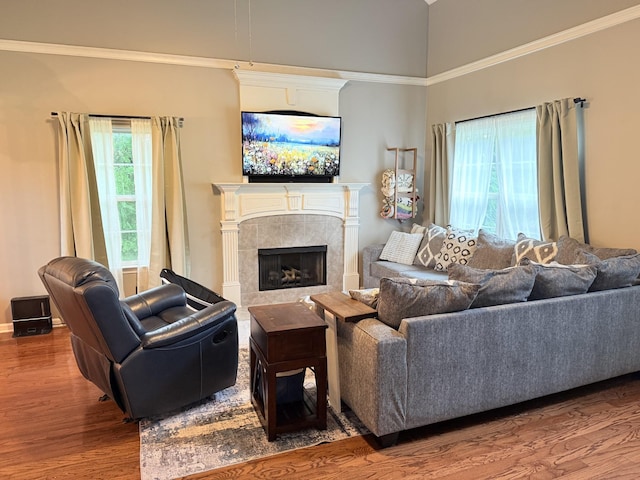 2415 Saint Andrews Dr, Murfreesboro, TN 37128 - living room featuring wood finished floors, a tiled fireplace, ornamental molding, and a high ceiling