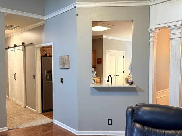 2415 Saint Andrews Dr, Murfreesboro, TN 37128 - corridor with dark wood-style floors, a barn door, ornamental molding, and decorative columns