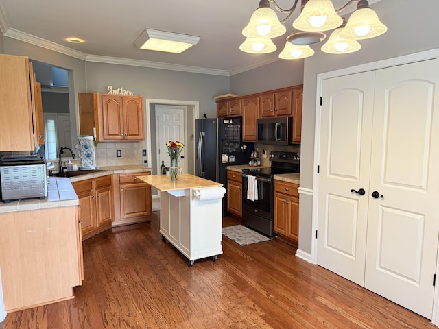 2415 Saint Andrews Dr, Murfreesboro, TN 37128 - kitchen featuring black appliances, light countertops, a chandelier, dark wood-style flooring, and crown molding
