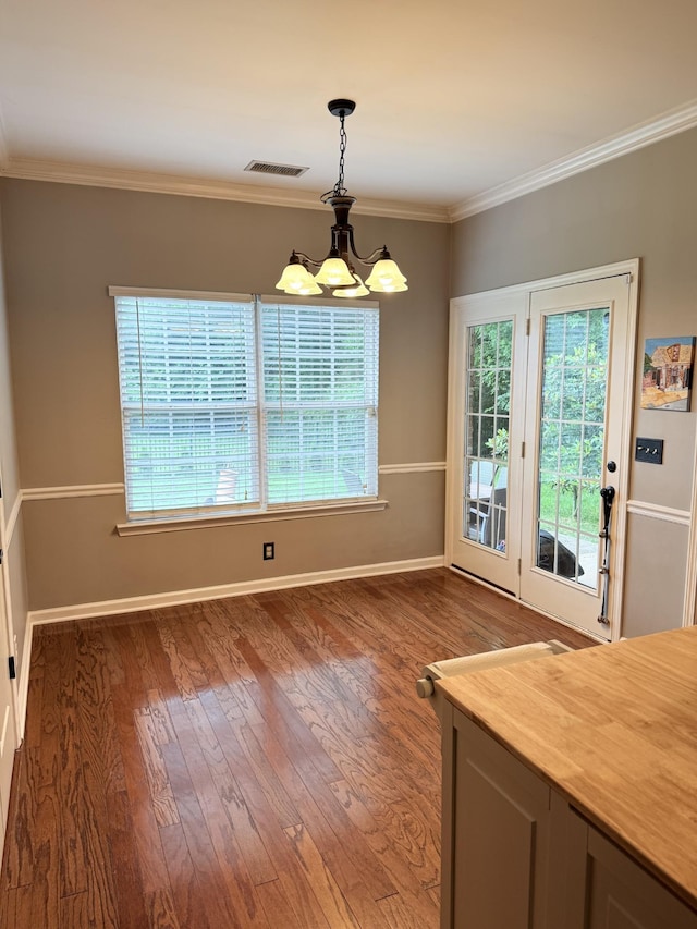 2415 Saint Andrews Dr, Murfreesboro, TN 37128 - unfurnished dining area with a chandelier, wood finished floors, and ornamental molding