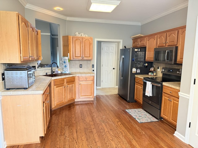 2415 Saint Andrews Dr, Murfreesboro, TN 37128 - kitchen with appliances with stainless steel finishes, tile countertops, ornamental molding, wood finished floors, and decorative backsplash