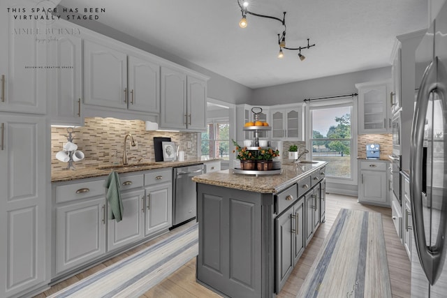 2103 Liebengood Rd, Goodlettsville, TN 37072 - kitchen with a sink, appliances with stainless steel finishes, gray cabinetry, and plenty of natural light