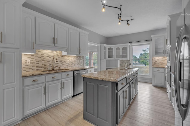 2103 Liebengood Rd, Goodlettsville, TN 37072 - kitchen with a sink, stainless steel appliances, gray cabinets, white cabinetry, and a kitchen island