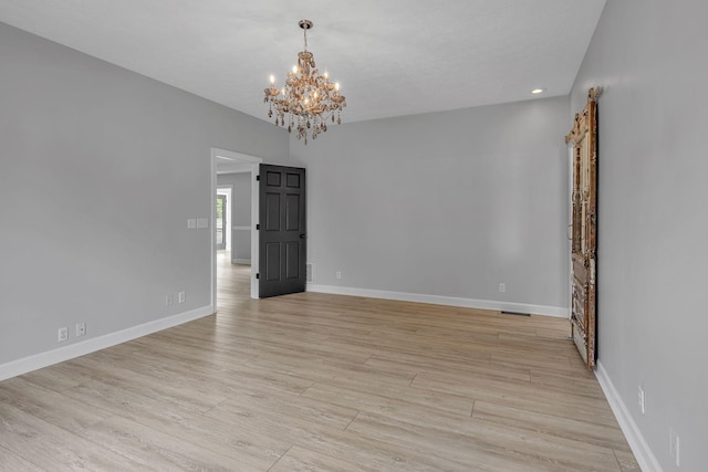 2103 Liebengood Rd, Goodlettsville, TN 37072 - empty room with a chandelier, baseboards, and light wood-style floors