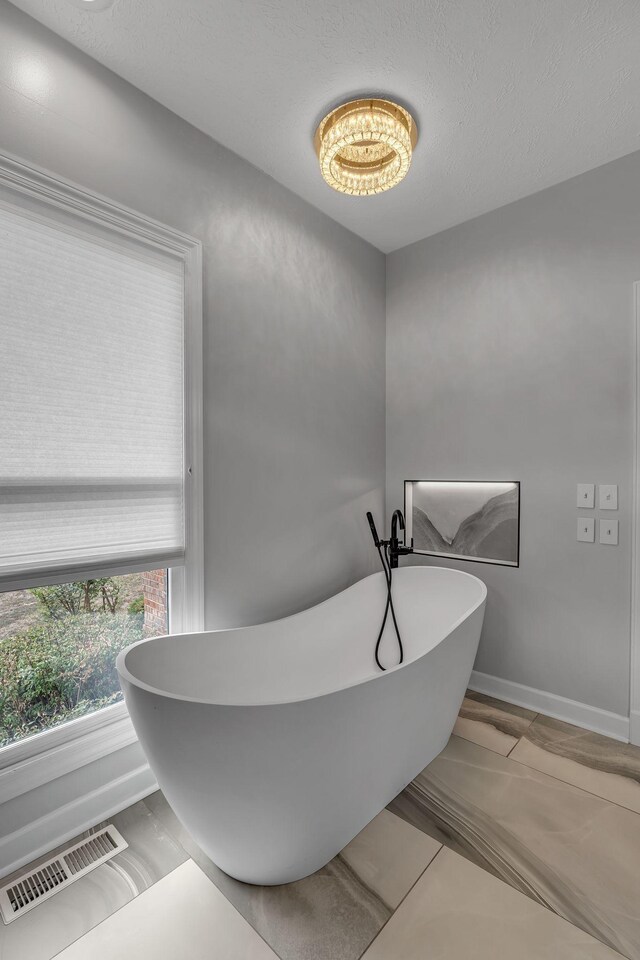 2103 Liebengood Rd, Goodlettsville, TN 37072 - bathroom with a freestanding bath and baseboards