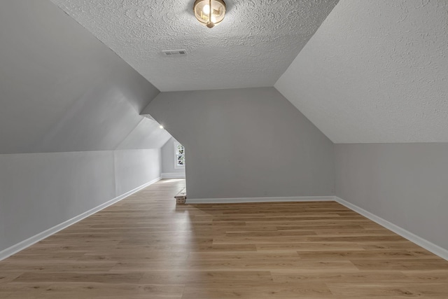 2103 Liebengood Rd, Goodlettsville, TN 37072 - bonus room with a textured ceiling, light wood-style flooring, baseboards, and lofted ceiling