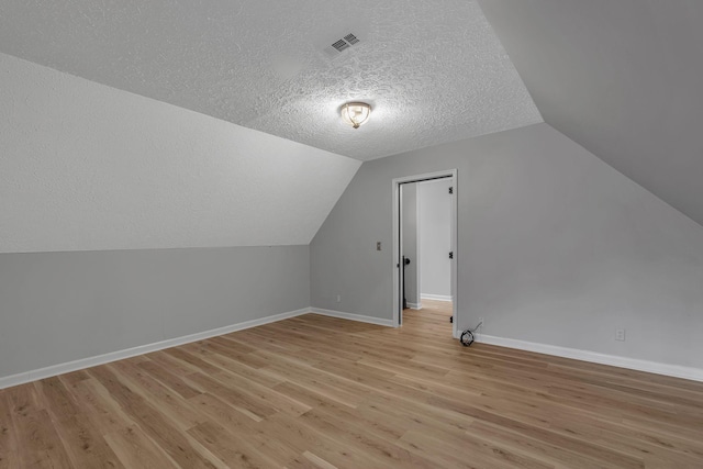 2103 Liebengood Rd, Goodlettsville, TN 37072 - bonus room with a textured ceiling, vaulted ceiling, light wood-style floors, and baseboards