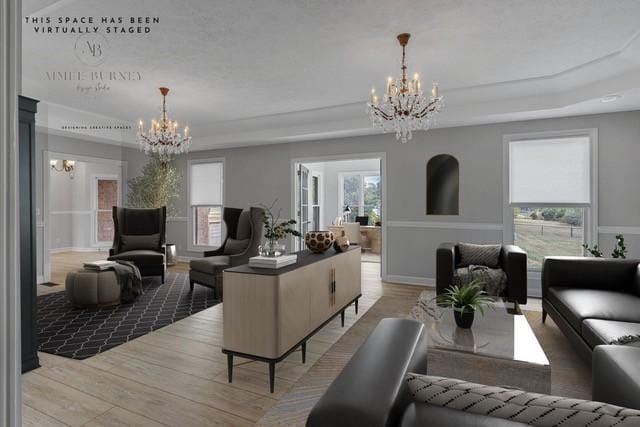 2103 Liebengood Rd, Goodlettsville, TN 37072 - living room featuring a chandelier, light wood-type flooring, and a tray ceiling