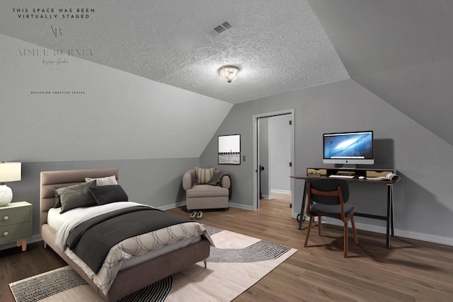 2103 Liebengood Rd, Goodlettsville, TN 37072 - bedroom featuring wood finished floors, a textured ceiling, baseboards, and lofted ceiling