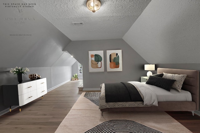 2103 Liebengood Rd, Goodlettsville, TN 37072 - bedroom featuring wood finished floors, a textured ceiling, baseboards, and vaulted ceiling