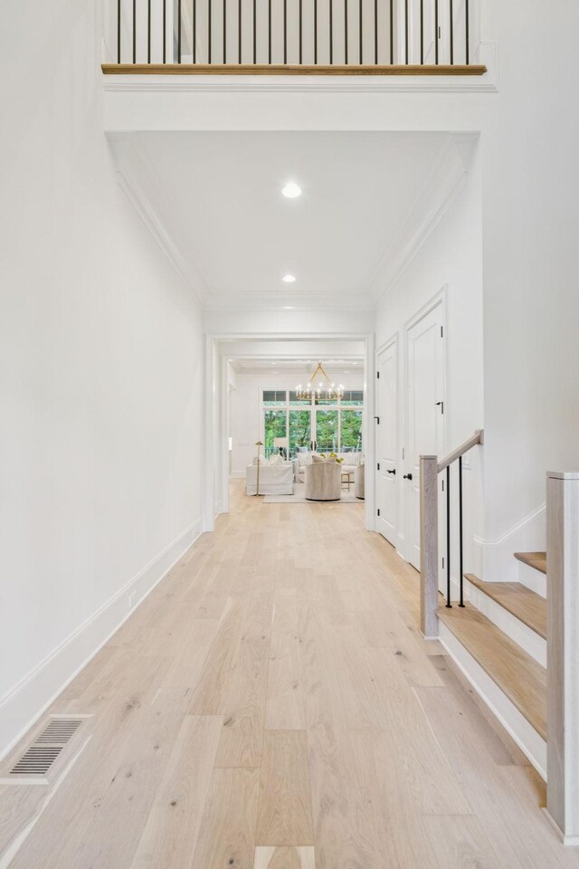 9314 Double Run Ct, College Grove, TN 37046 - hallway featuring a chandelier, ornamental molding, wood finished floors, stairway, and recessed lighting