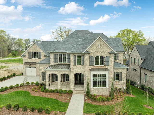 9314 Double Run Ct, College Grove, TN 37046 - french country inspired facade with covered porch, a shingled roof, concrete driveway, a standing seam roof, and a front yard