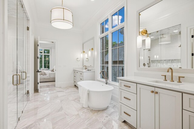 9314 Double Run Ct, College Grove, TN 37046 - bathroom featuring a stall shower, two vanities, crown molding, a freestanding tub, and marble tiled flooring