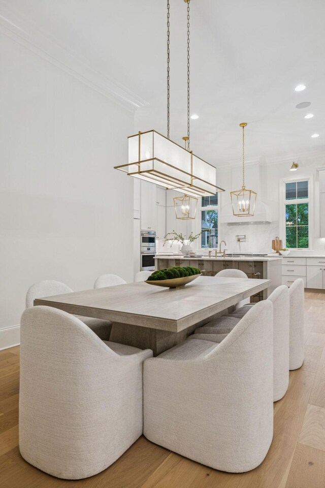 9314 Double Run Ct, College Grove, TN 37046 - dining space featuring a chandelier, recessed lighting, plenty of natural light, light wood-style floors, and crown molding