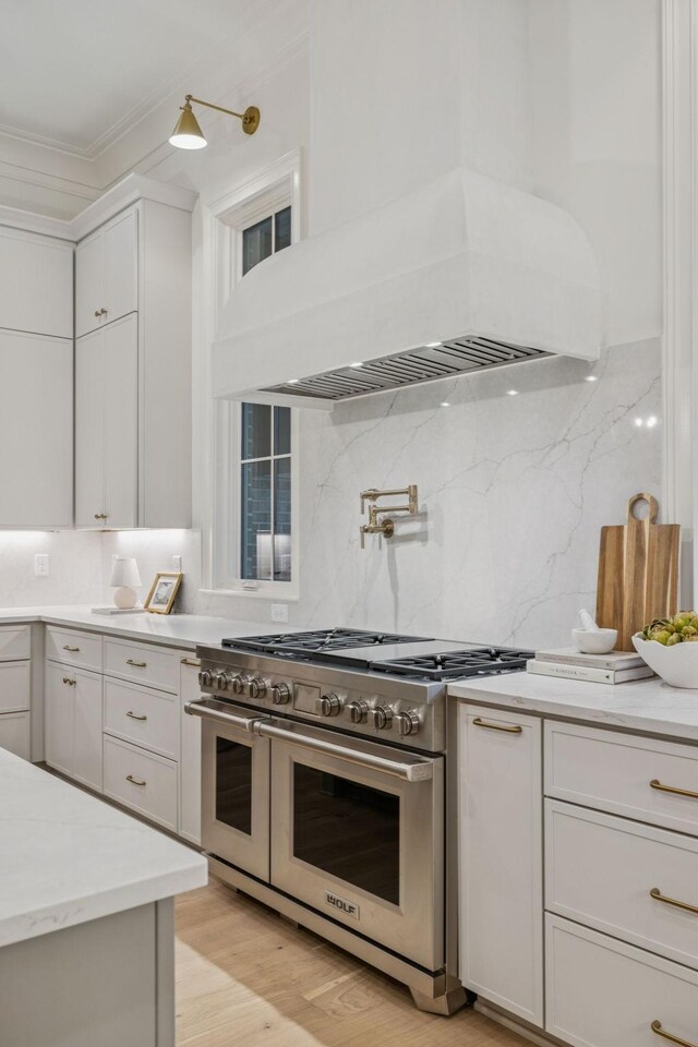 9314 Double Run Ct, College Grove, TN 37046 - kitchen with range with two ovens, premium range hood, crown molding, decorative backsplash, and light wood-style floors